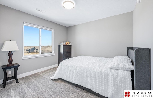 carpeted bedroom featuring visible vents and baseboards