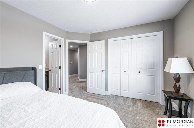 bedroom with a closet, carpet flooring, visible vents, and baseboards