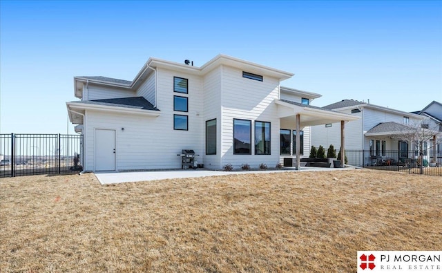 back of house featuring a yard, a patio, and fence