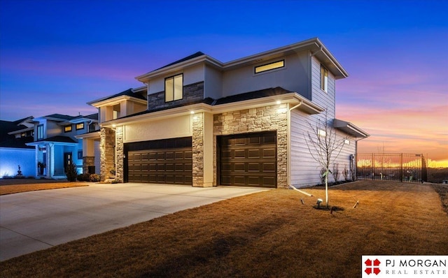 view of front of property with a garage, driveway, stone siding, fence, and stucco siding