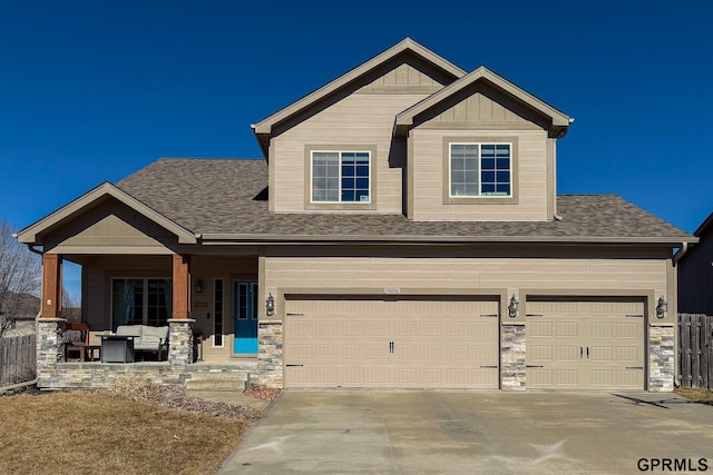 craftsman house with covered porch, board and batten siding, a garage, stone siding, and driveway