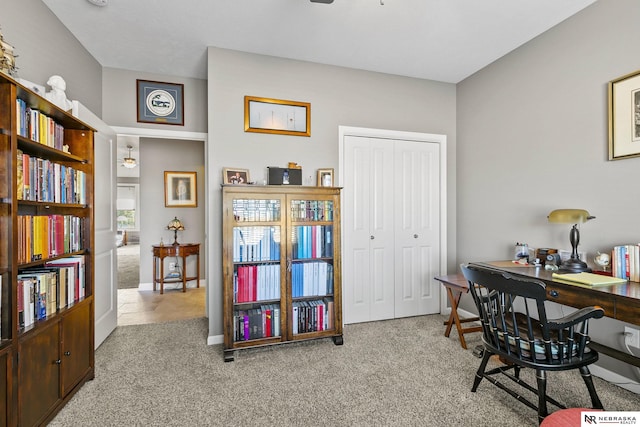 carpeted home office featuring baseboards