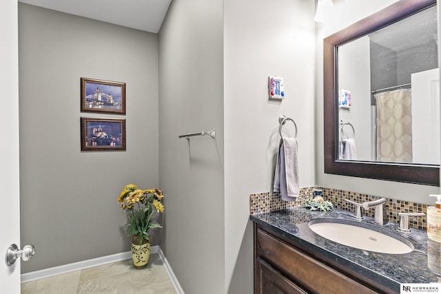 bathroom with backsplash, vanity, and baseboards