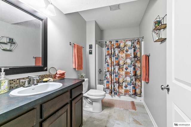 bathroom featuring vanity, toilet, shower / bath combo with shower curtain, and baseboards