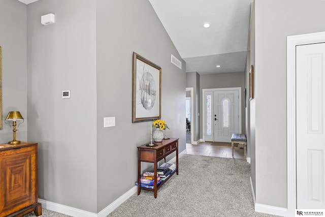 carpeted entrance foyer featuring visible vents, recessed lighting, and baseboards