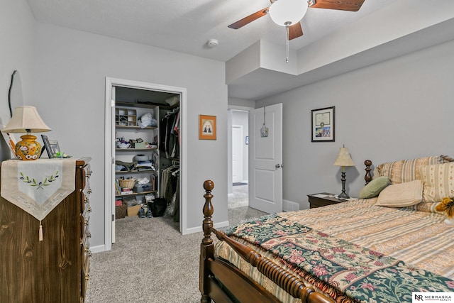 bedroom featuring visible vents, a closet, baseboards, light colored carpet, and a spacious closet