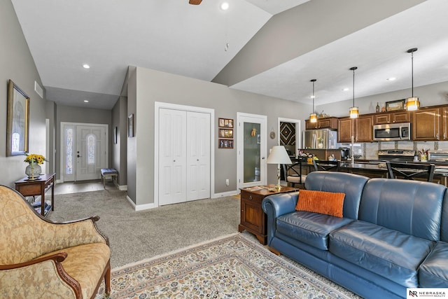 living area with baseboards, light colored carpet, vaulted ceiling, recessed lighting, and a ceiling fan