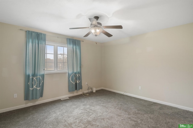 empty room with carpet, visible vents, baseboards, and ceiling fan