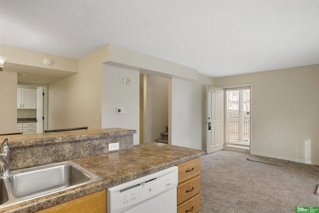 kitchen with light colored carpet, a sink, baseboards, dishwasher, and dark countertops