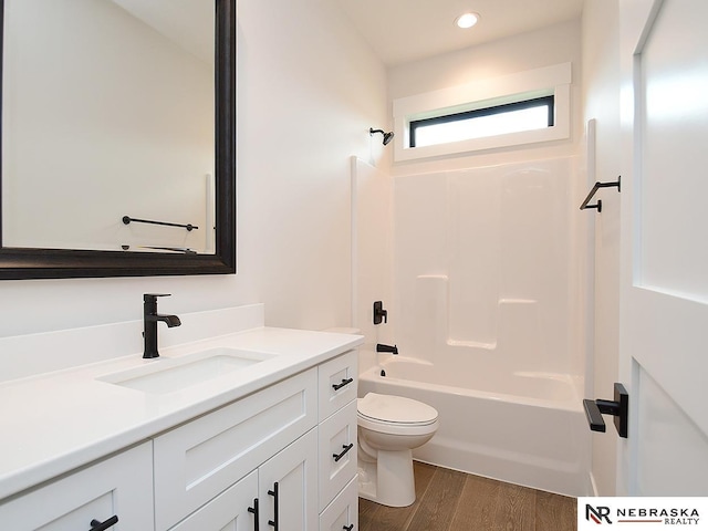 full bathroom featuring recessed lighting, shower / bathing tub combination, toilet, vanity, and wood finished floors