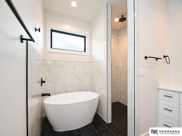 full bath with tiled shower, a soaking tub, tile patterned flooring, tile walls, and recessed lighting