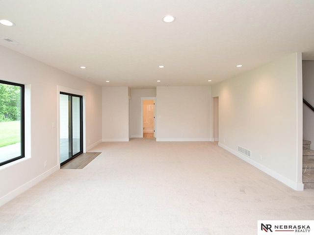 spare room with stairway, visible vents, and recessed lighting