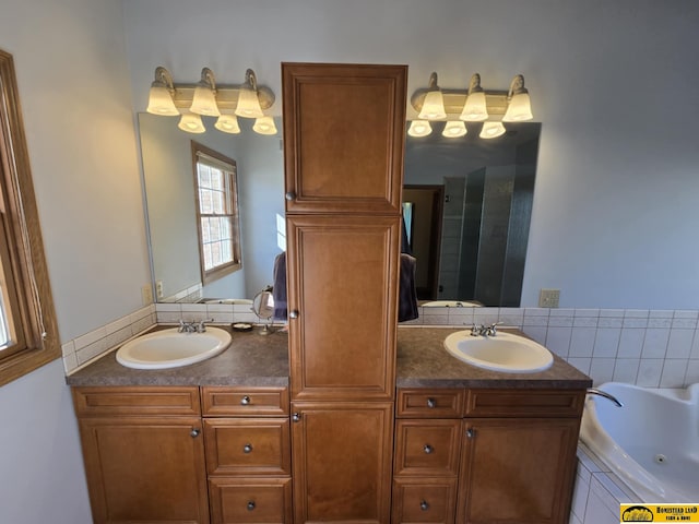 full bath with a sink, a whirlpool tub, and double vanity