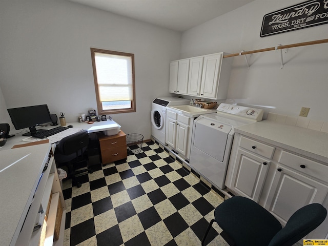 laundry area with washer and dryer, cabinet space, a sink, and light floors