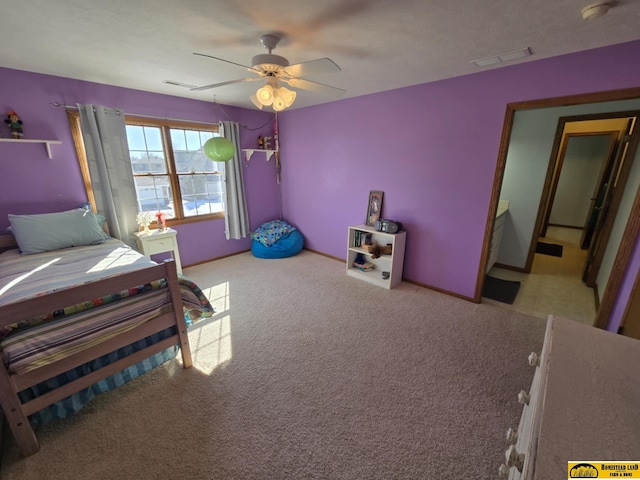 carpeted bedroom featuring a ceiling fan, visible vents, and baseboards