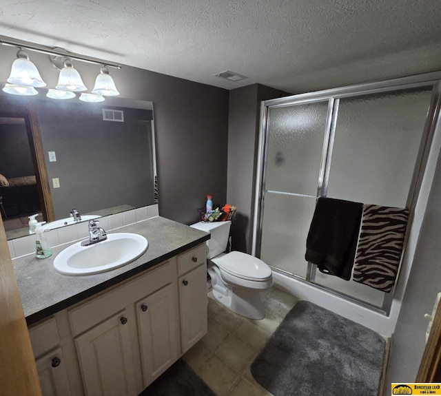 full bath with visible vents, toilet, a textured ceiling, vanity, and a shower stall