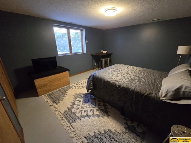 bedroom featuring a textured ceiling and carpet floors