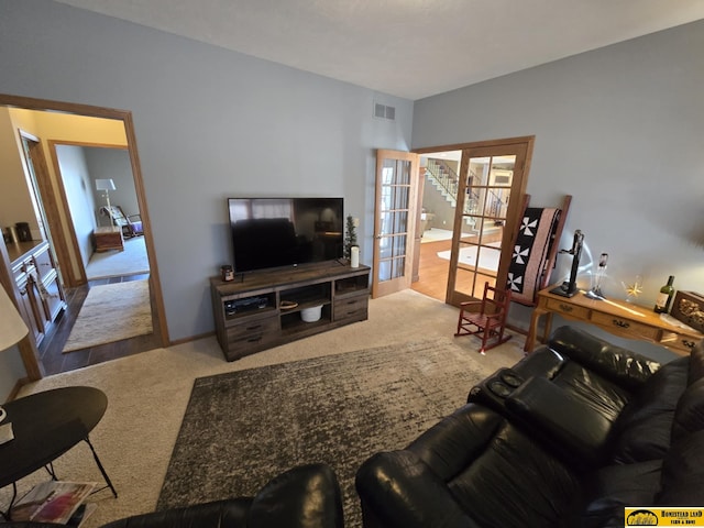 carpeted living area with visible vents and french doors