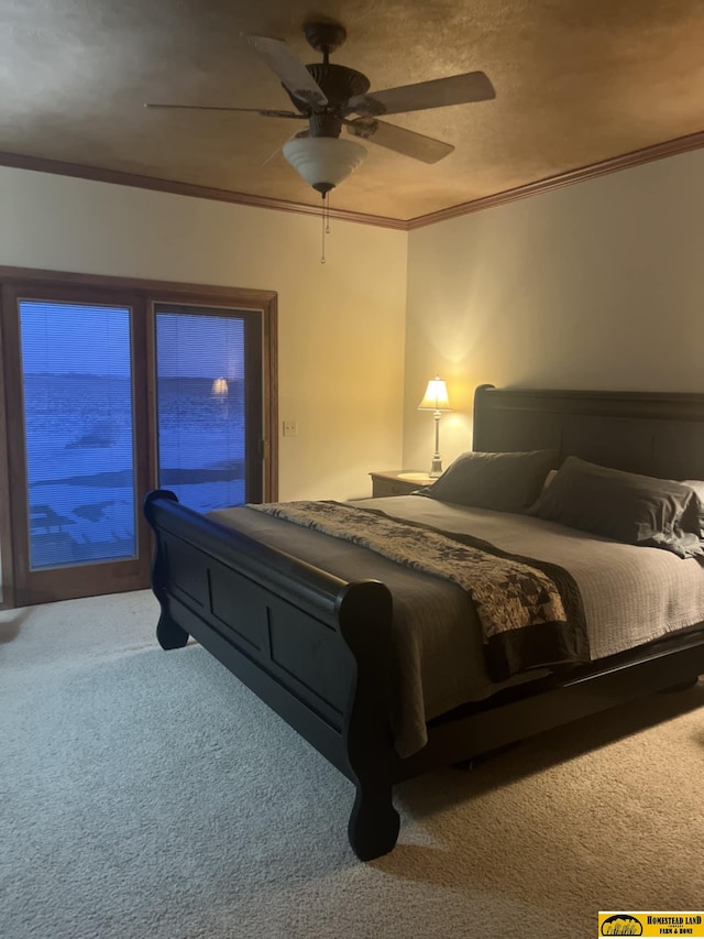 carpeted bedroom with ornamental molding and ceiling fan