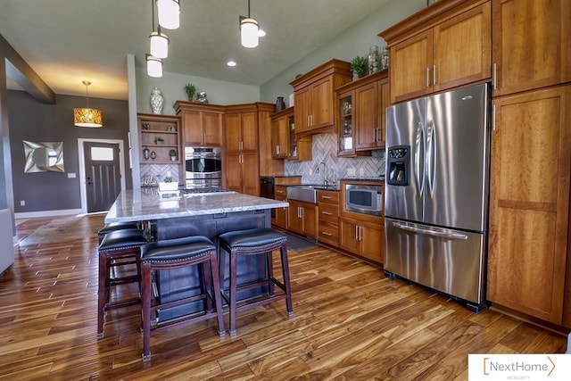 kitchen featuring stainless steel appliances, dark wood-style flooring, decorative backsplash, open shelves, and brown cabinetry