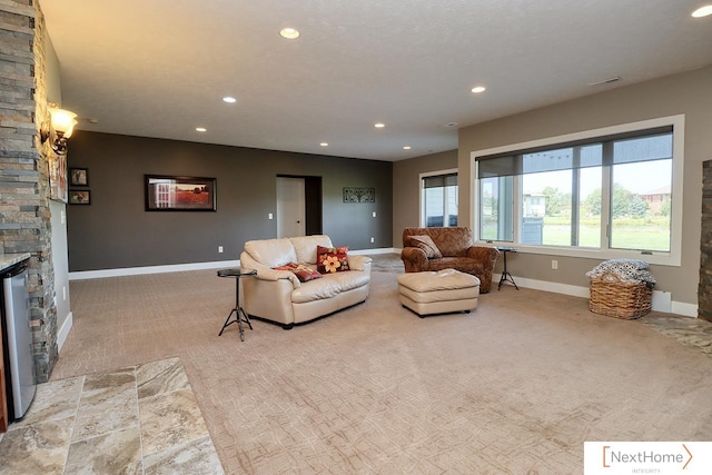 carpeted living area with baseboards, a fireplace, and recessed lighting