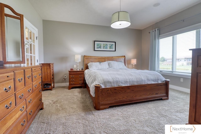 bedroom with carpet flooring and baseboards