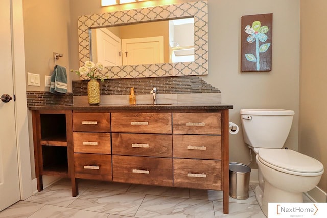 bathroom featuring marble finish floor, backsplash, and vanity