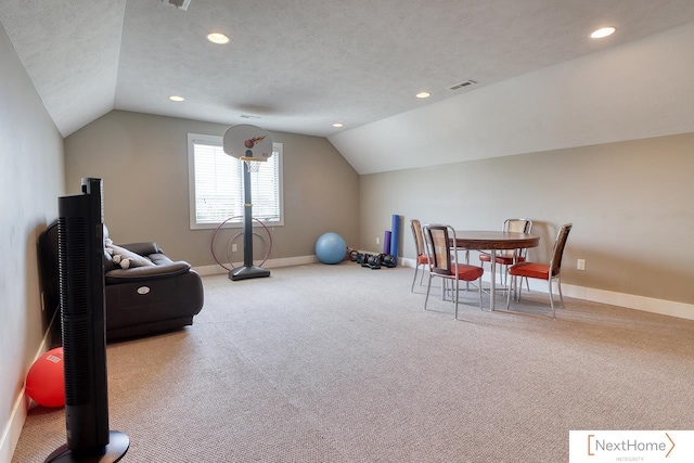 workout area with lofted ceiling, baseboards, and a textured ceiling