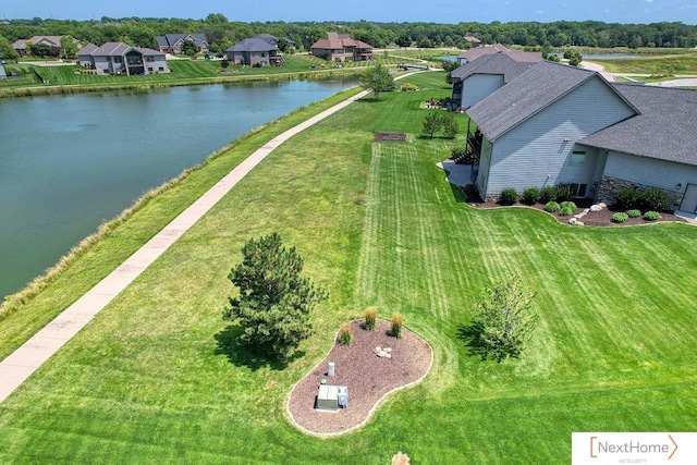 drone / aerial view featuring a water view and a residential view