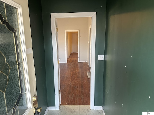 hall with visible vents and baseboards