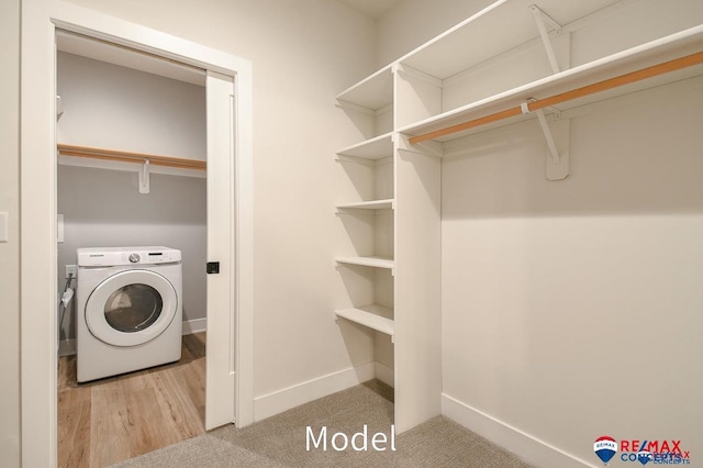 washroom featuring washer / dryer, baseboards, laundry area, and wood finished floors