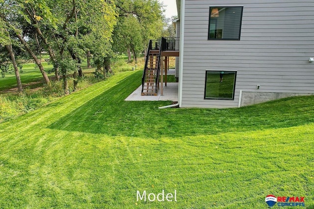 view of yard with a patio and stairs