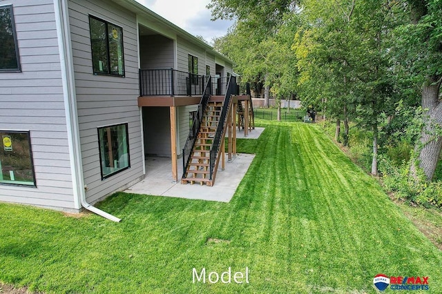 view of yard featuring a patio area, stairs, and a wooden deck