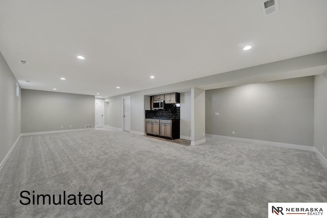 unfurnished living room with recessed lighting, visible vents, and baseboards