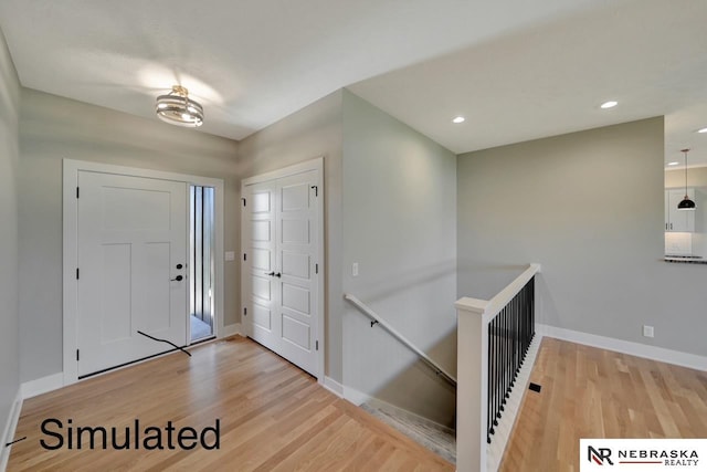 entrance foyer featuring baseboards, wood finished floors, and recessed lighting