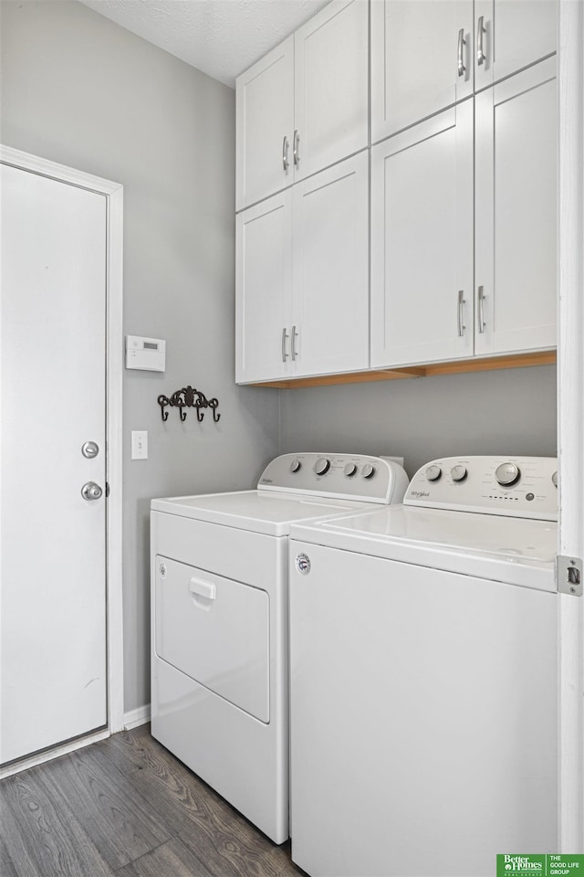 washroom with cabinet space, a textured ceiling, dark wood-style flooring, and independent washer and dryer