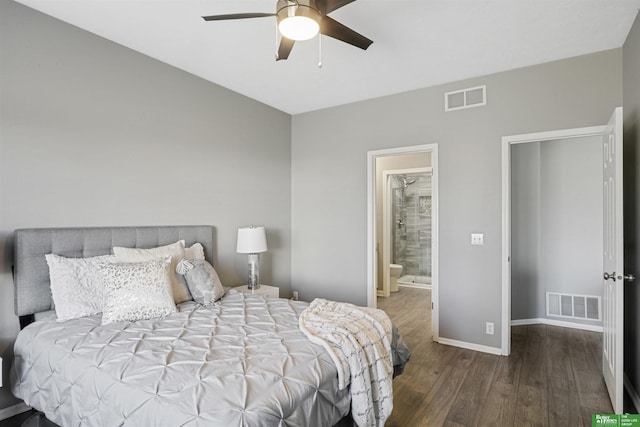 bedroom featuring visible vents, ensuite bath, baseboards, and wood finished floors