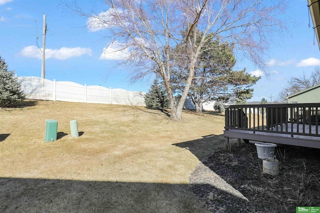 view of yard featuring fence and a wooden deck