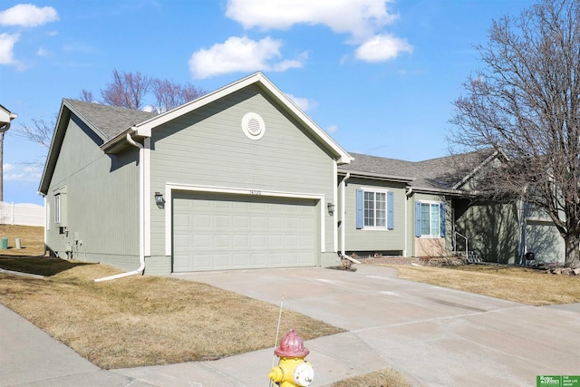 ranch-style home with a shingled roof and concrete driveway