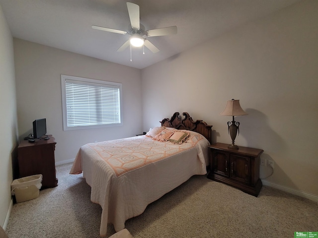 bedroom with baseboards, a ceiling fan, and light colored carpet