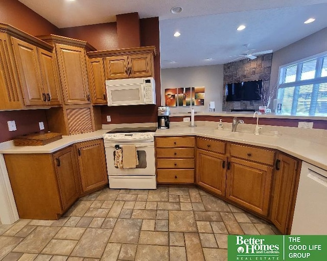 kitchen featuring white appliances, ceiling fan, light countertops, a sink, and recessed lighting