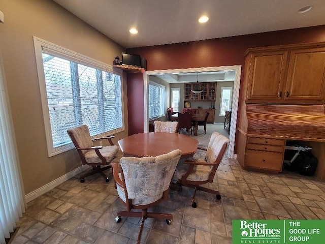 dining space with baseboards, stone tile flooring, and recessed lighting