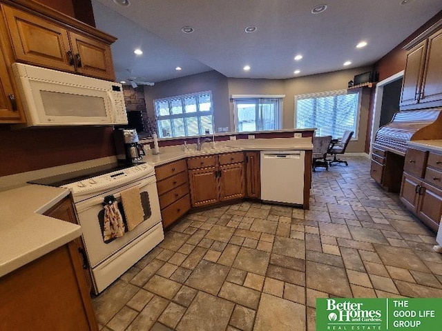 kitchen featuring recessed lighting, white appliances, light countertops, and a healthy amount of sunlight