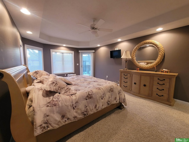 bedroom with access to exterior, recessed lighting, a raised ceiling, light colored carpet, and a ceiling fan