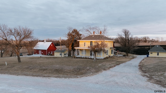 view of front of property featuring a balcony, covered porch, and a garage