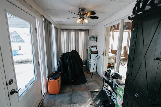 interior space featuring a drop ceiling and ceiling fan