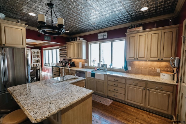 kitchen featuring an ornate ceiling, freestanding refrigerator, crown molding, and a sink