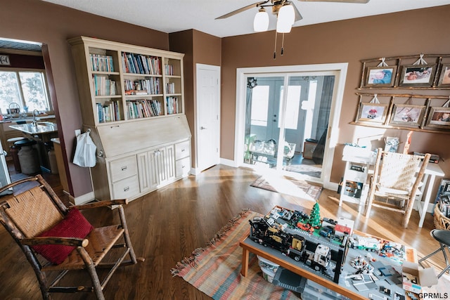 interior space with ceiling fan, baseboards, wood finished floors, and french doors