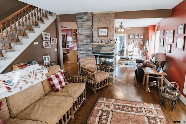 living room with a fireplace, a ceiling fan, and wood finished floors