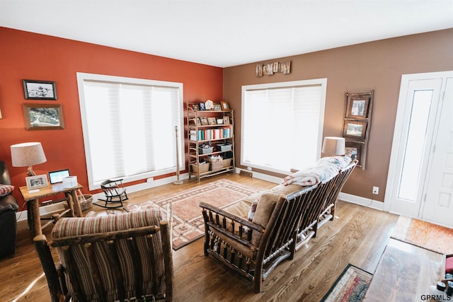 living room with baseboards and wood finished floors